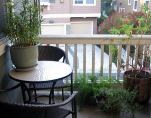 Bistro table and decorative plants on our center balcony - yes, two balconies making for great outdoor space.