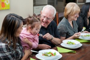 Family enjoying meal in new home