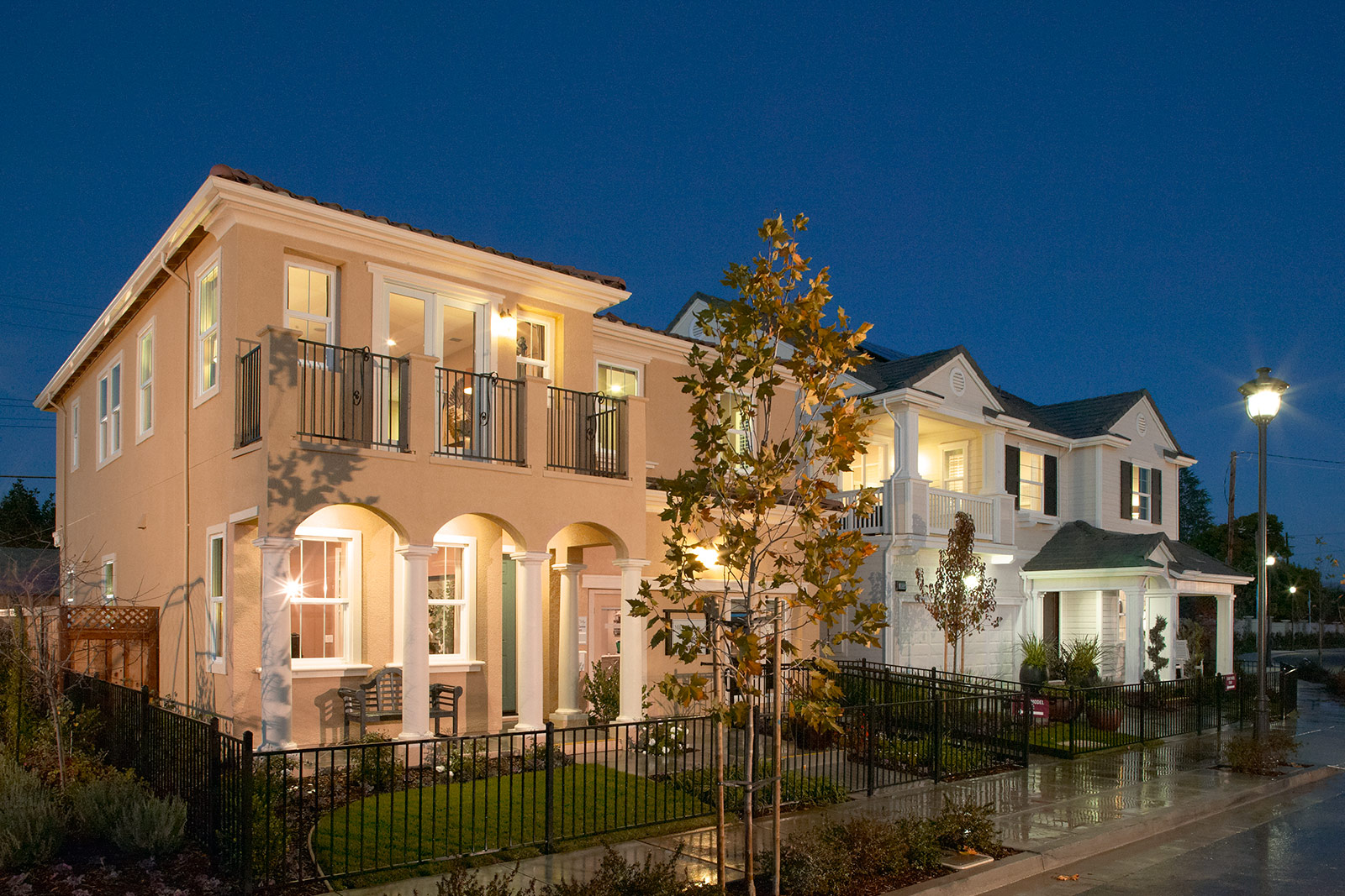 Modern bedroom by SummerHill Homes with accent wall, large bed, and balcony access.