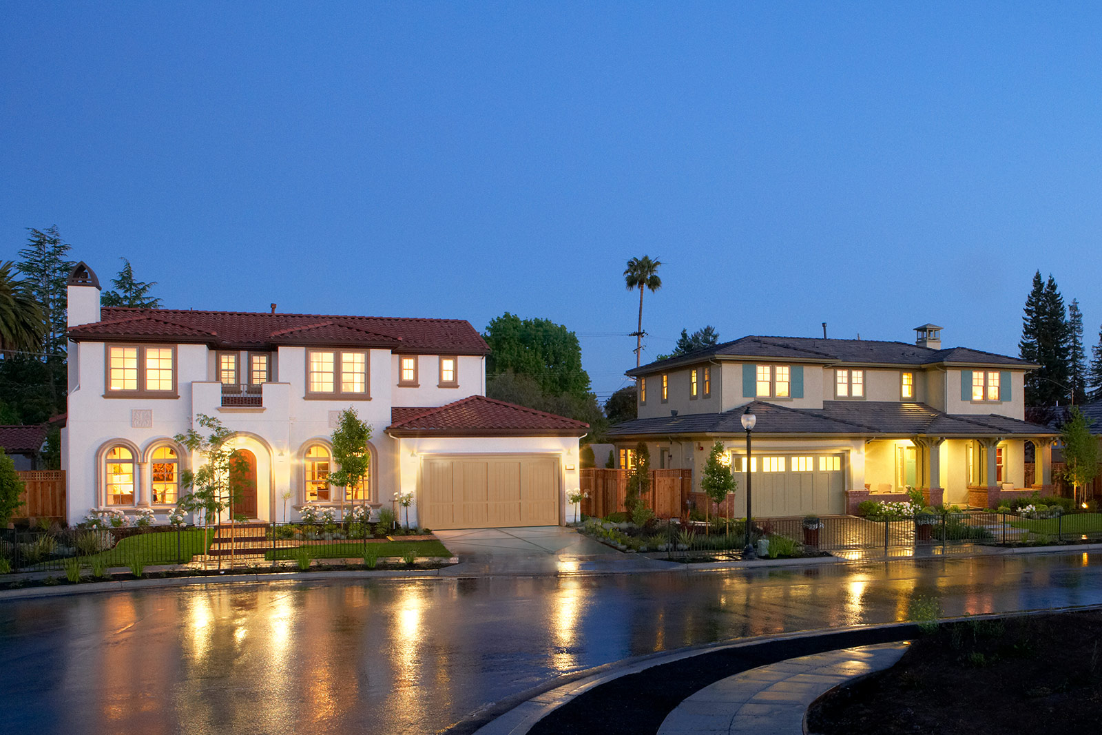 Modern bedroom by SummerHill Homes with accent wall, large bed, and balcony access.