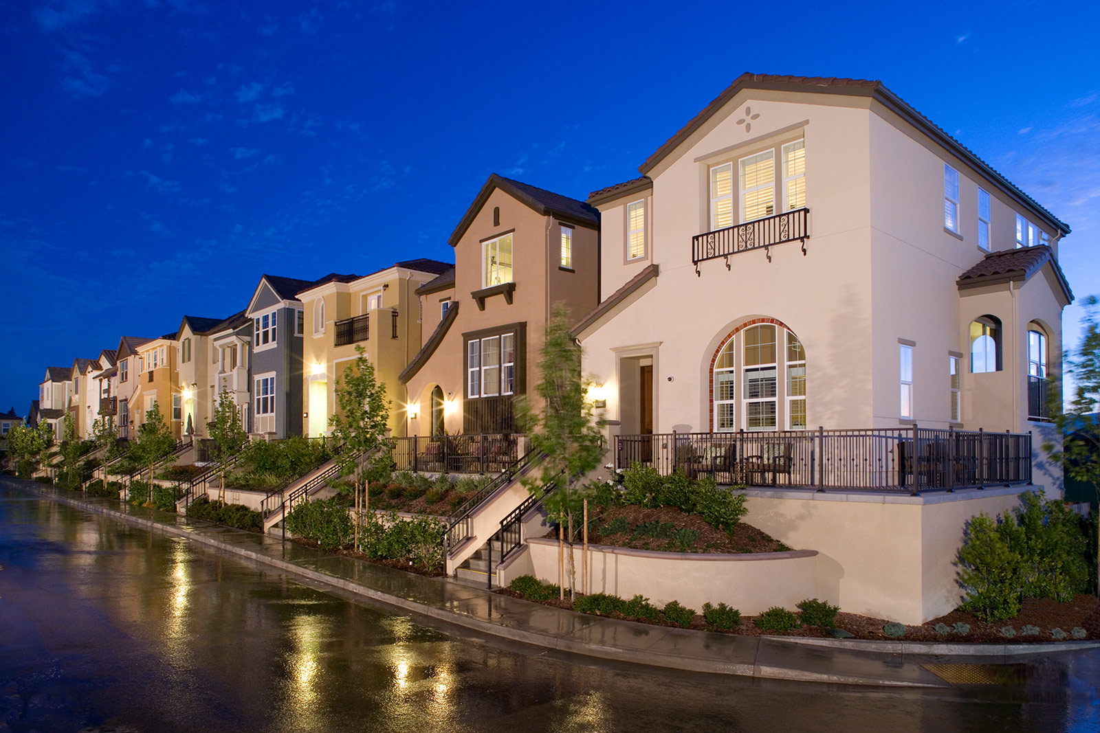 Colorful, contemporary townhomes by SummerHill Homes showcasing bold architecture, modern design, and landscaped walkways.