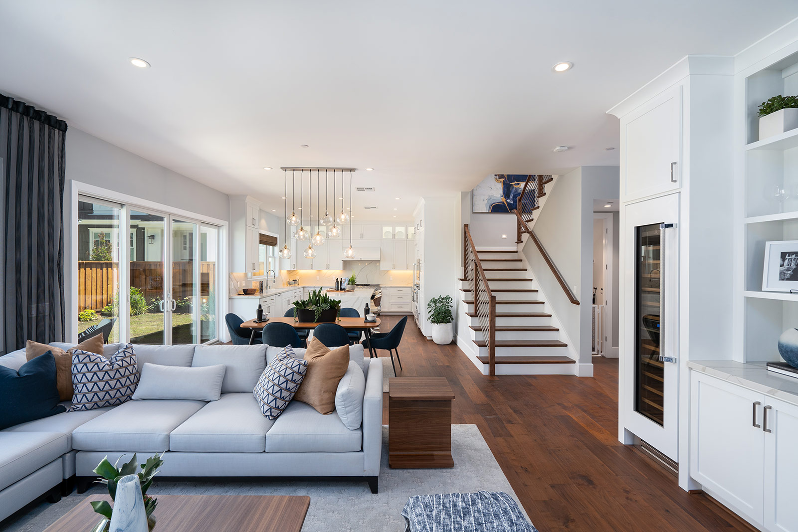 Elegant kitchen by SummerHill Homes featuring a large island with seating, sleek cabinetry, and modern pendant lighting.