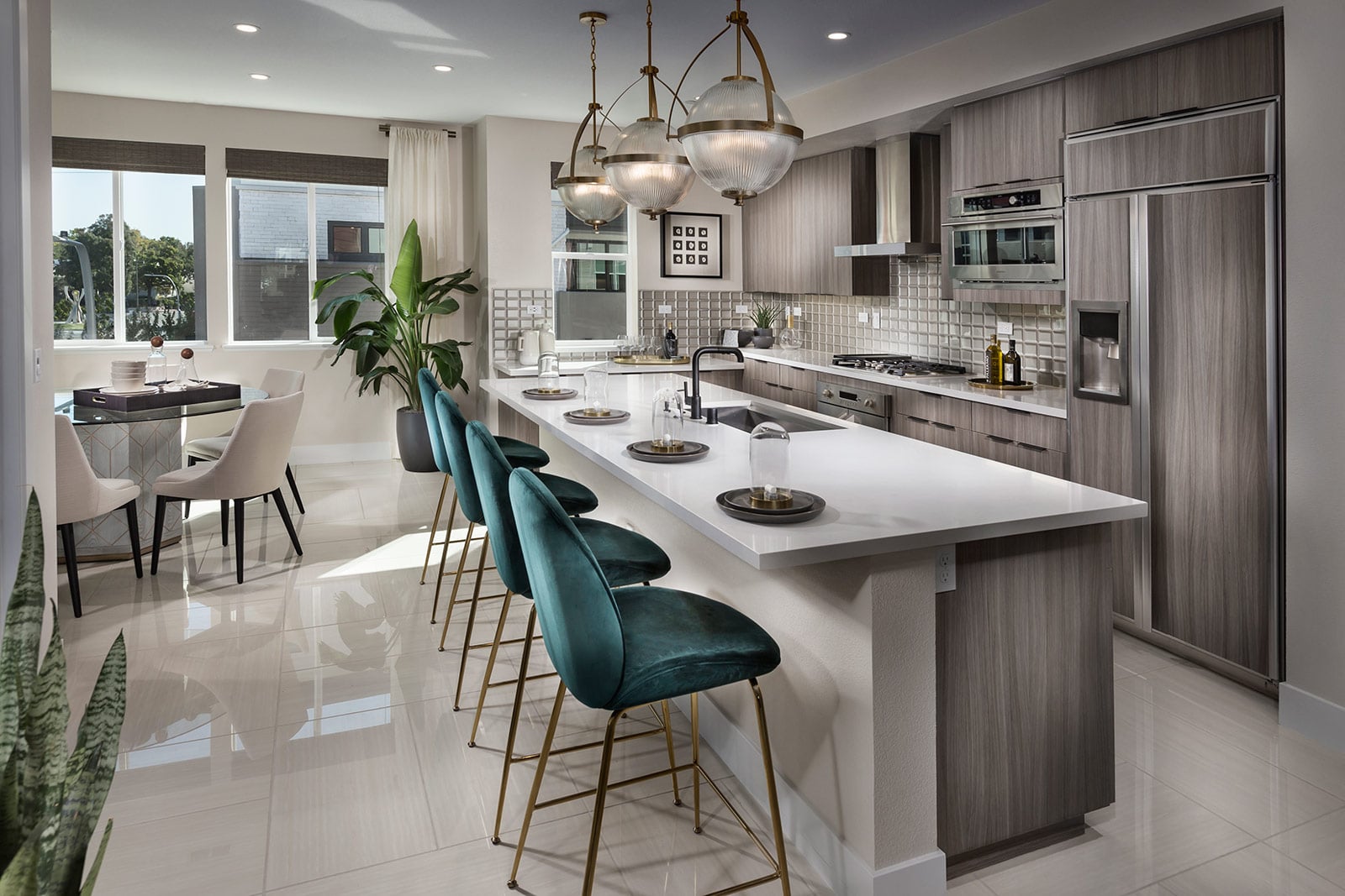 Modern kitchen with brown cabinetry, large quartz island, and tile flooring.